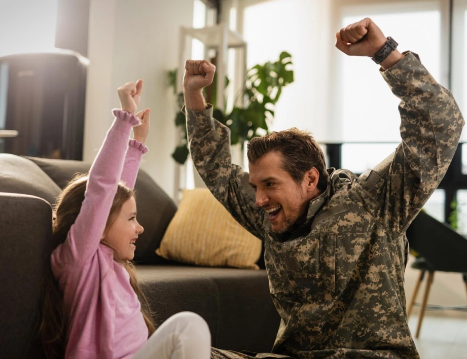 a joyful moment of reunion between a military service member and their young child